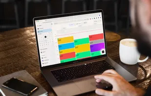 Customer managing appointments using Booklux booking software on a laptop in a café.